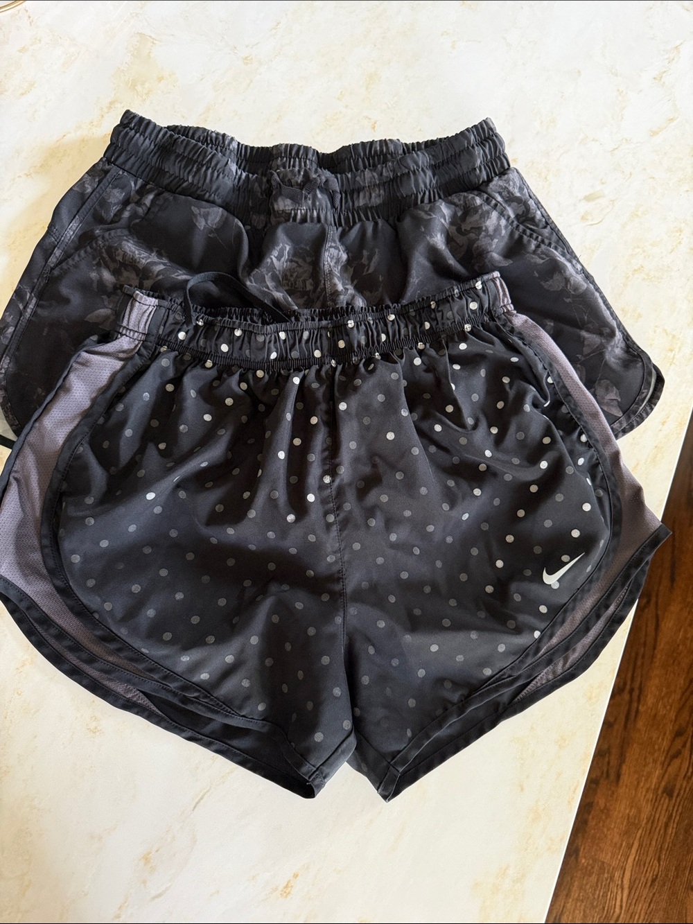 Two pairs: Nike Women’s Black Polka Dot Athletic Shorts & black and gray floral